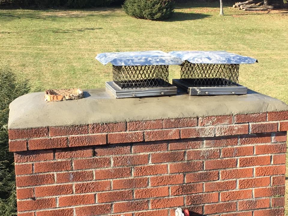 Rebuilt brick chimney with new crown and caps