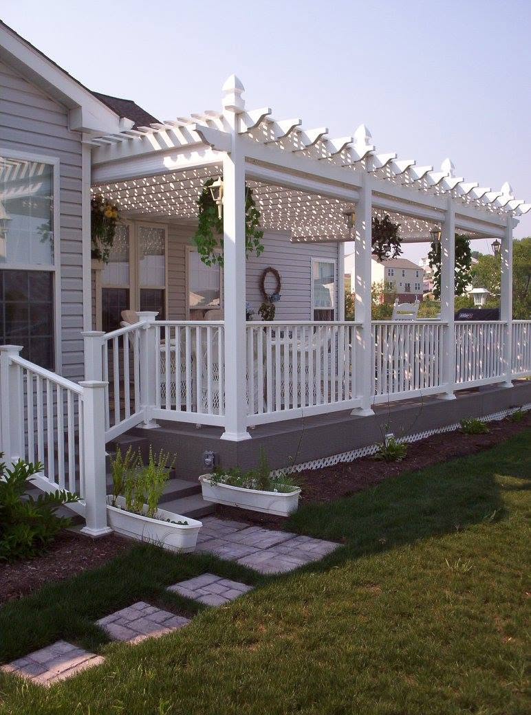 White covered porch with railings and hanging planters